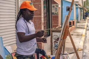 BAYAHIBE DOMINICAN REPUBLIC 21 JANUARY 2020 Dominican painter street artist in Bayahibe photo