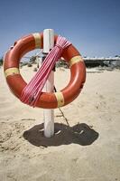 The life buoy hanging on the beach photo