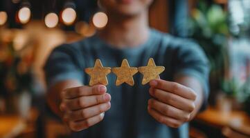 Man Holding Three Gold Stars photo