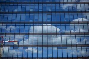 Clouds reflected on a glass building photo