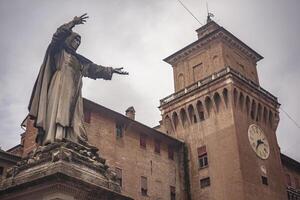 Ferrara's castle in Italy with statue photo