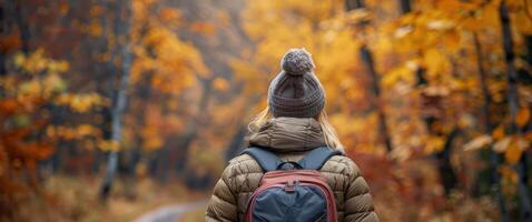 Woman in Blue Jacket Walking Through Forest photo