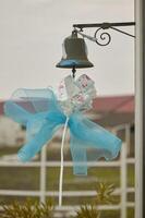 Blue bow hanging from a bell photo