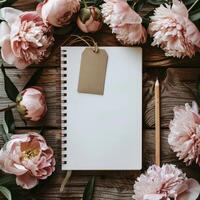 Notepad, Pencil, and Flowers on Wooden Table photo