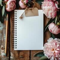 Notepad, Pencil, and Flowers on Wooden Table photo