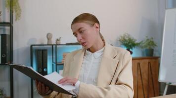 Business woman at home office analysing paperwork documents, shocked by sudden victory good news wow video