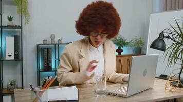 Focused business woman girl at office reads social media news accidentally spilled water on laptop video