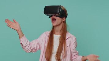 Excited girl using headset helmet app to play simulation game, watching virtual reality 3D 360 video