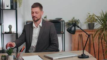 Businessman in suit working on smartphone, doing manager job, typing message to client, office room video