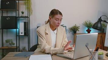Businesswoman working on laptop meditating doing yoga breathing exercise in lotus position at office video