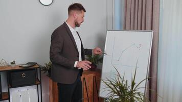 Businessman holds online meeting presentation or training on whiteboard financial strategy at office video