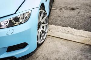 Tuned car headlight detail. Macro view of modern blue car photo