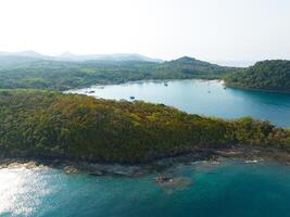 Aerial drone view of beautiful rocky with turquoise sea water and trees of Gulf of Thailand. Kood island, Thailand photo