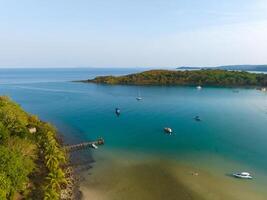 Aerial drone view of beautiful beach with turquoise sea water and palm trees of Gulf of Thailand. Kood island, Thailand photo