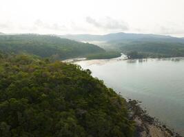 Aerial drone view of beautiful beach with turquoise sea water and trees of Gulf of Thailand. Kood island, Thailand photo