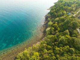 Aerial drone view of beautiful beach with turquoise sea water and trees of Gulf of Thailand. Kood island, Thailand photo