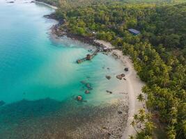 Aerial drone view of beautiful beach with turquoise sea water and palm trees of Gulf of Thailand. Kood island, Thailand photo