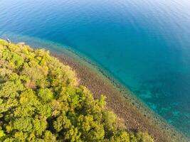 Aerial drone view of beautiful beach with turquoise sea water and trees of Gulf of Thailand. Kood island, Thailand photo