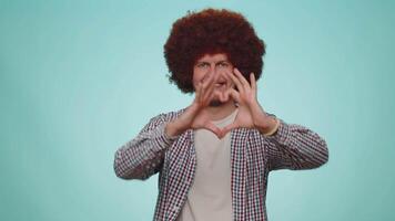 Smiling man makes heart gesture demonstrates love sign expresses good feelings and sympathy video