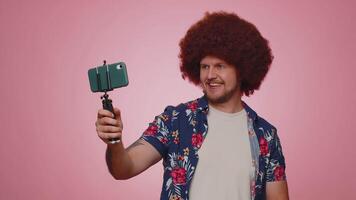 Man blogger take selfie on mobile phone selfie stick communicate call online with subscribers video