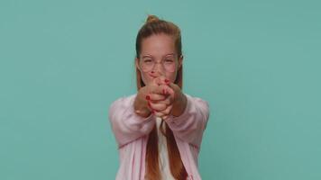 Pretty confident child girl pointing around with finger gun gesture, making choice, shooting killing video