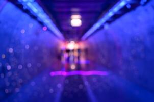 Blur abstract corridor tunnel with colorful bokeh lights background photo