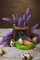 Quail eggs near the nest and lavender flowers on a stone background. Easter Postcard photo