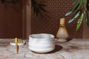 Tea ceremony from the matcha. Tyawan, tyasaku, tyasen on a stone table top among bamboo leaves with copy space photo