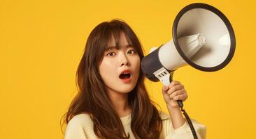 Cheerful of cute Asian woman holding megaphone making announcement. photo