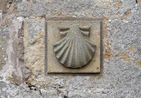 Scallop shell symbol on a church along the Camino de Santiago pilgrimage trail photo