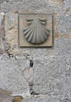 Scallop shell symbol on a church along the Camino de Santiago pilgrimage trail photo