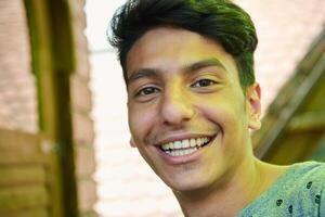 Middle Eastern Man with a Radiant Smile and Beautiful White Teeth Captured in Closeup photo