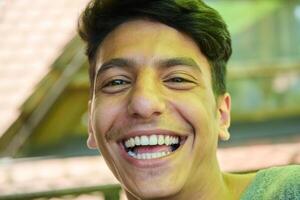 Middle Eastern Man with a Radiant Smile and Beautiful White Teeth Captured in Closeup photo