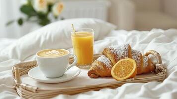 Savoring a Luxurious Breakfast in Bed with Coffee, Orange Juice, and a Golden Croissant photo