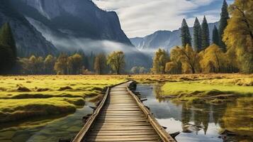 Low clouds lay in the valley. Meadow with boardwalk in National Park Valley at autumn morning. photo