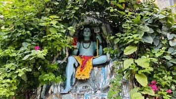 hindu god mahadev sitting in cave with trishul photo