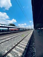 train standing on railway track , railway station photo