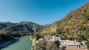 view of rishikesh, river and mountains photo