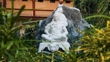 white statue of lord shiva doing meditation photo
