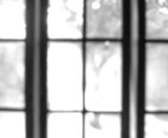 Black and white photo of blurry window glass frame out of focus, out of focus on photo inside the house