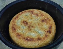 Photo of hardened rice, dry rice on magic com, the rice is dry and then hardened until it turns brownish. burnt rice, crusty rice