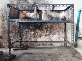 The iron table that houses the trader's stove looks dirty, the table has been used for annual trading photo
