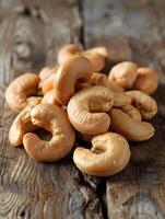 Close-up of cashews on rustic wooden surface photo