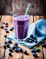 Delicious Blueberry Juice Smoothie in a Glass with a Straw photo