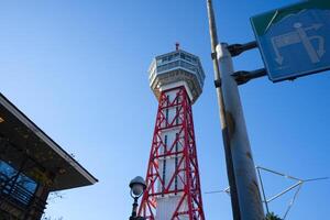 looking up view of Hakata Port Tower, a red lattice metal observation tower in the Hakata district of Fukuoka, Japan photo