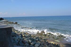 View of waves breaking on the beach photo