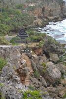 Sceniv view of rocks and Hindu temple in Ngobaran Beach photo