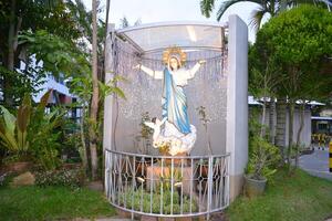 Statue of Mother Marry in the yard of a church photo