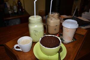 Various variants of coffee drinks are served on the table photo