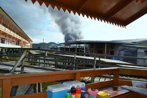 View of fire smoke in the water village, Bandar Seri Begawan photo